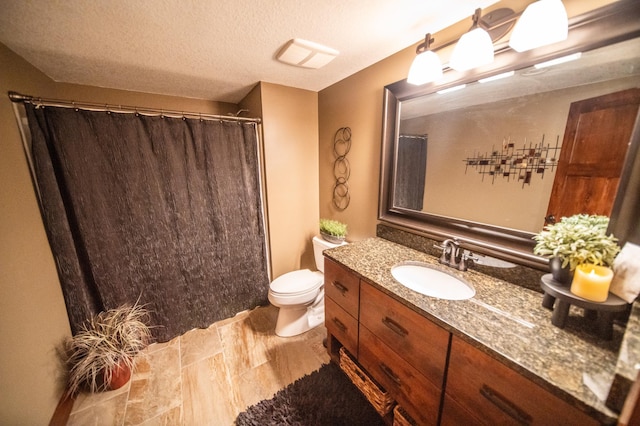2441 Rosewood Ln SW, Rochester, MN 55902 - bathroom featuring vanity, toilet, a textured ceiling, and a shower with curtain