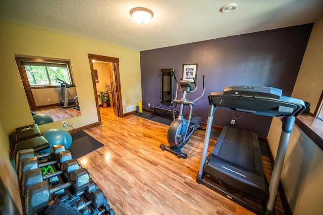 2441 Rosewood Ln SW, Rochester, MN 55902 - exercise area featuring wood finished floors and baseboards