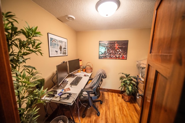 2441 Rosewood Ln SW, Rochester, MN 55902 - home office featuring wood finished floors, a textured ceiling, and baseboards
