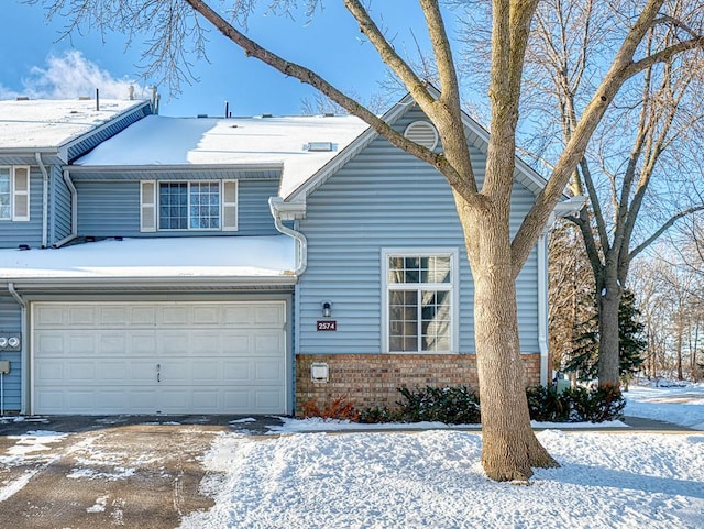 traditional home featuring a garage and brick siding