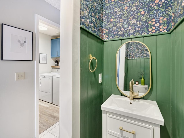 bathroom with a textured ceiling, washing machine and dryer, and vanity