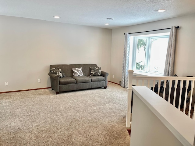 living room with carpet floors and a textured ceiling