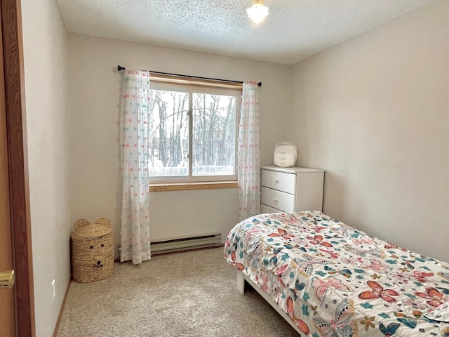 carpeted bedroom with a baseboard radiator and a textured ceiling