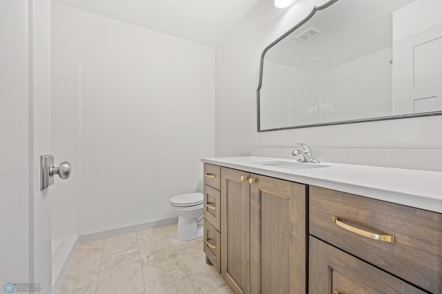 bathroom featuring vanity and toilet