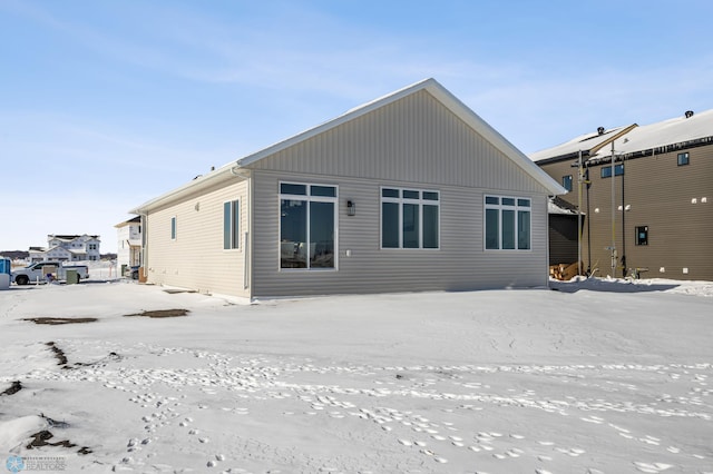 view of snow covered rear of property