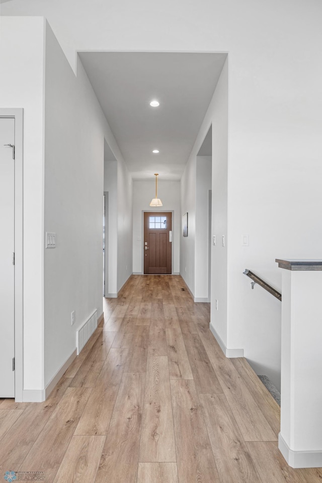 foyer entrance with baseboards, recessed lighting, light wood-style flooring, and visible vents