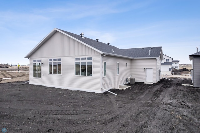 back of property with roof with shingles and cooling unit