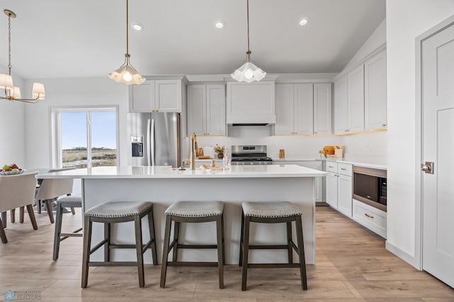 8334 61st St S, Horace, ND 58047 - kitchen with appliances with stainless steel finishes, a sink, a breakfast bar, an island with sink, and recessed lighting