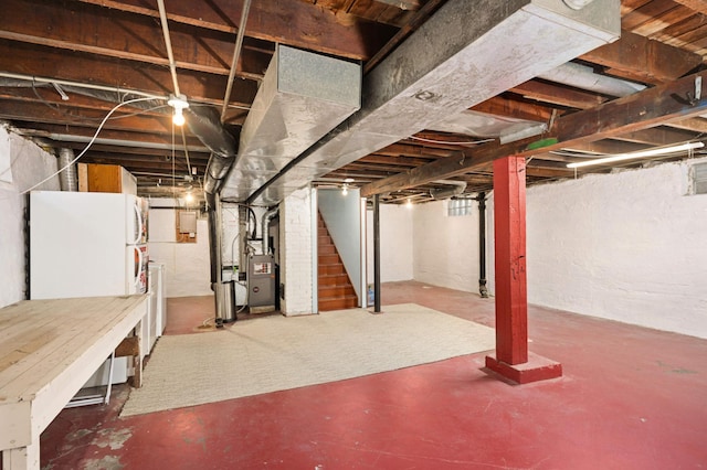 basement with white refrigerator and heating unit