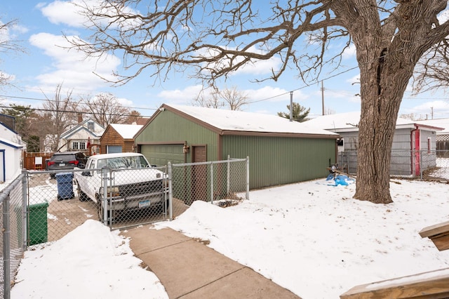 view of front of property with a garage and an outdoor structure