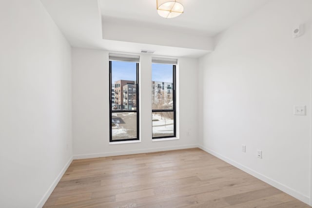 spare room with light wood-type flooring