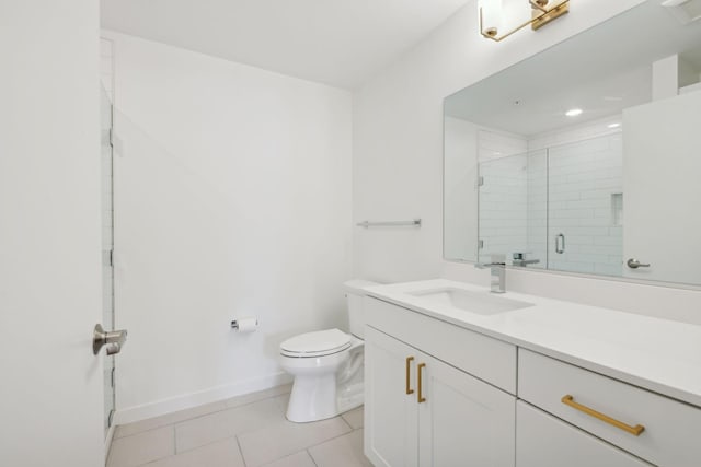 bathroom with tile patterned flooring, vanity, a shower with door, and toilet