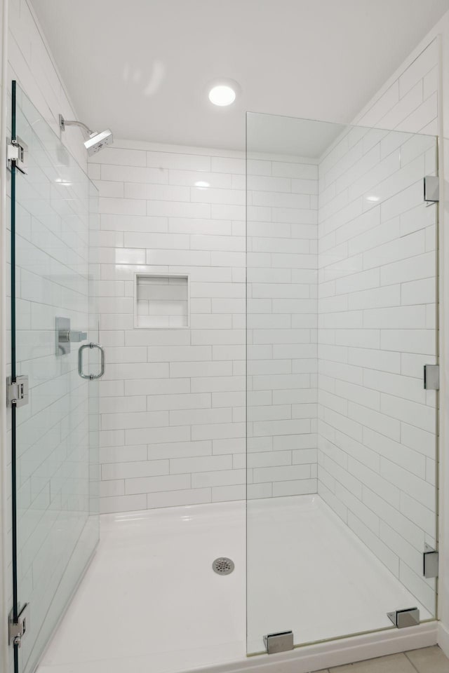 bathroom featuring a shower with door