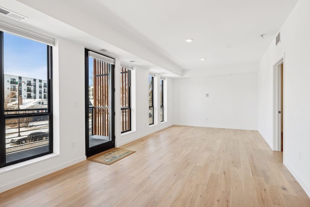 spare room featuring light wood-type flooring