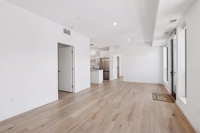 unfurnished living room with light hardwood / wood-style flooring