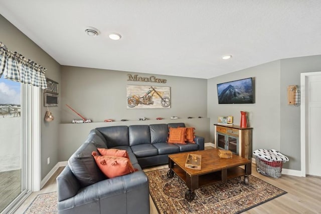 living area featuring recessed lighting, light wood-type flooring, and baseboards