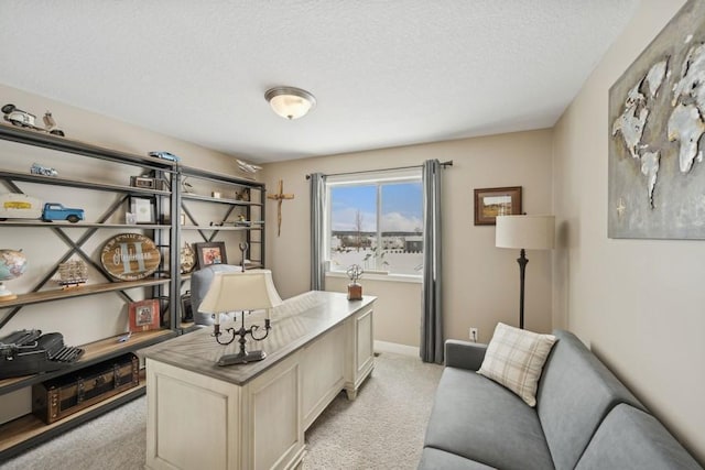 office area featuring light carpet, a textured ceiling, and baseboards