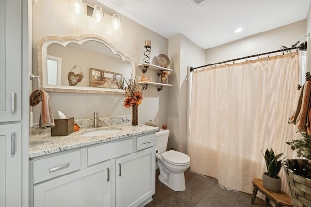 bathroom with toilet, curtained shower, tile patterned flooring, and vanity