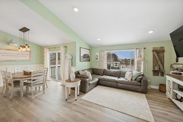 living area featuring vaulted ceiling, wainscoting, light wood-style flooring, and recessed lighting