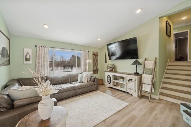 living room with lofted ceiling, stairway, wood finished floors, and recessed lighting