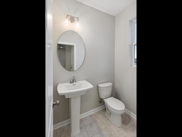 bathroom featuring sink, tile patterned floors, and toilet