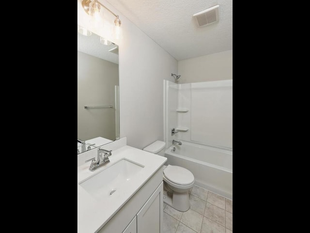 full bathroom with shower / washtub combination, tile patterned flooring, vanity, toilet, and a textured ceiling