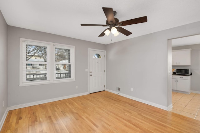 unfurnished room featuring ceiling fan and light hardwood / wood-style floors