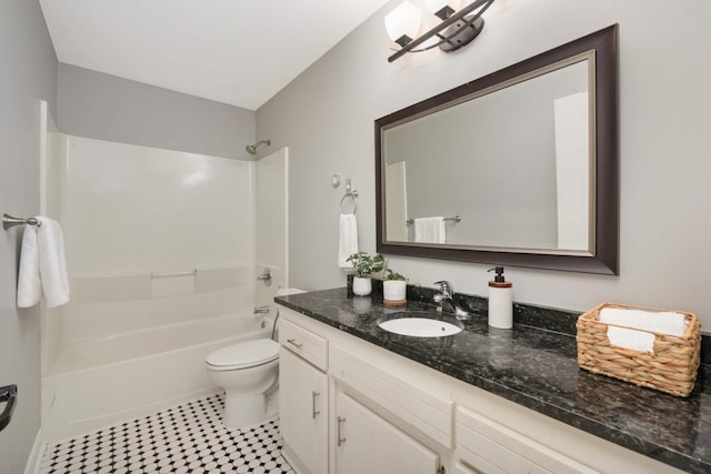 full bathroom with vanity, tile patterned floors, toilet, and washtub / shower combination