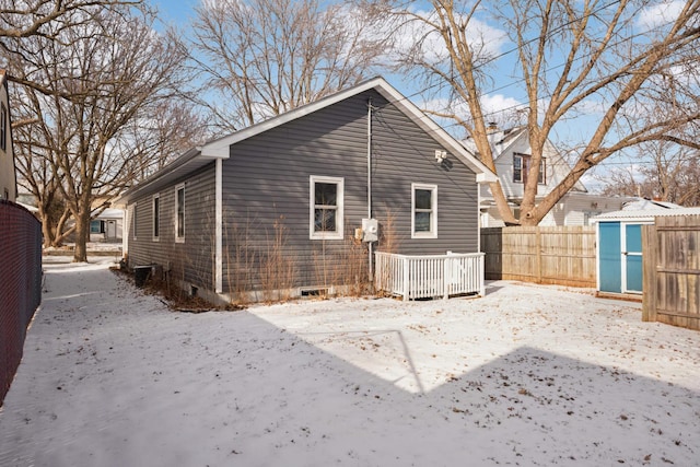 view of snow covered rear of property