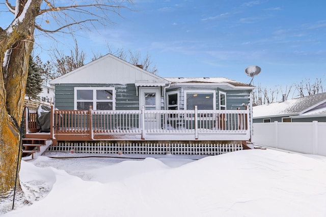 view of front facade with a deck and fence