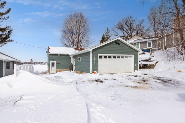 view of front facade featuring a garage and an outdoor structure