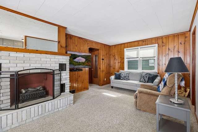 living room featuring light carpet, a fireplace, and wooden walls