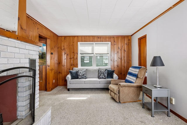 living area featuring light carpet, wood walls, a fireplace, and crown molding