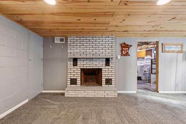 unfurnished living room featuring carpet floors, a fireplace, visible vents, wooden ceiling, and baseboards