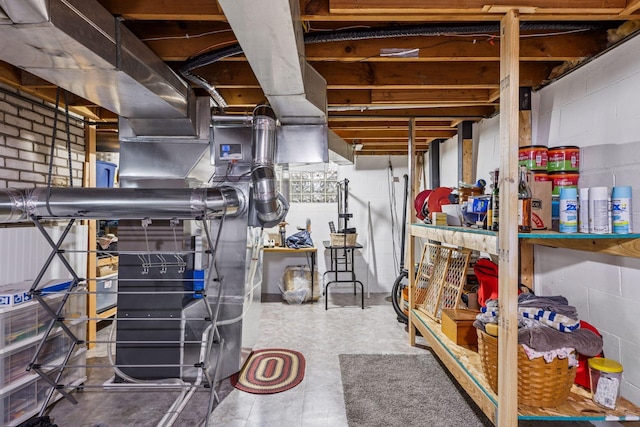 unfinished basement featuring concrete block wall