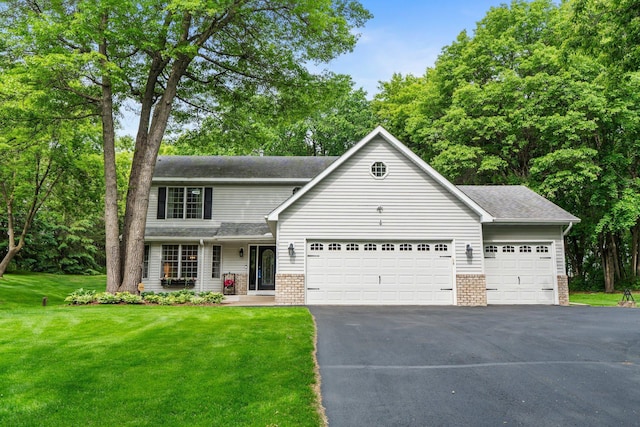 17130 Uplander Cir NW, Andover, MN 55304 - view of front facade featuring driveway, brick siding, an attached garage, a front lawn, and a shingled roof