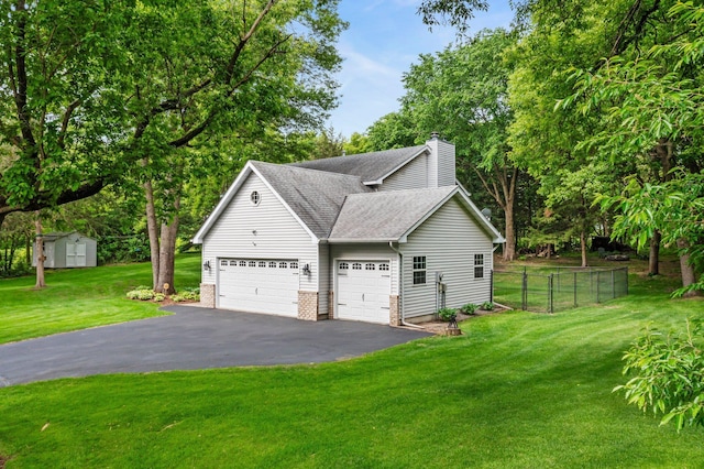 17130 Uplander Cir NW, Andover, MN 55304 - view of side of home with driveway, a shingled roof, a garage, a chimney, and view of scattered trees