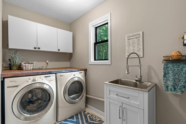 17130 Uplander Cir NW, Andover, MN 55304 - laundry area with cabinet space, independent washer and dryer, a textured ceiling, tile patterned flooring, and baseboards