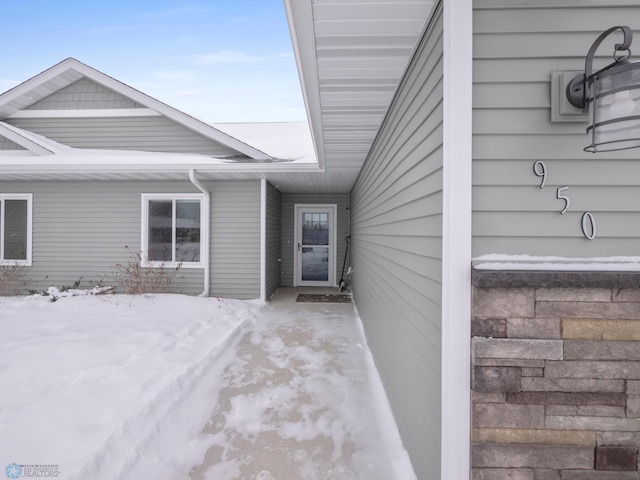 view of snow covered property entrance