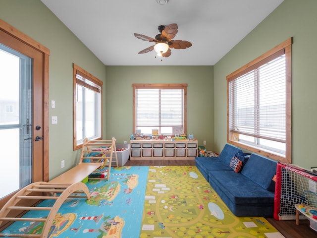 playroom with hardwood / wood-style flooring, ceiling fan, and a wealth of natural light