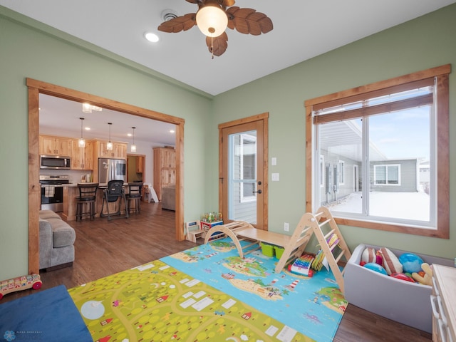 rec room featuring dark wood-type flooring and ceiling fan