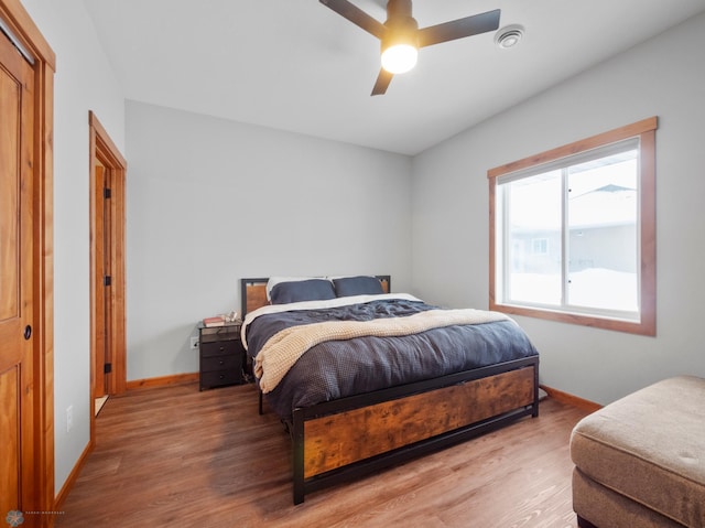 bedroom with hardwood / wood-style flooring and ceiling fan