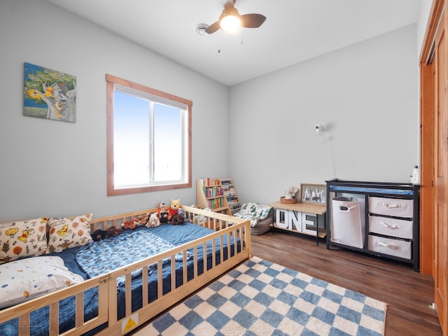 bedroom featuring dark hardwood / wood-style flooring and ceiling fan