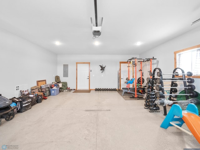 garage with a garage door opener and electric panel