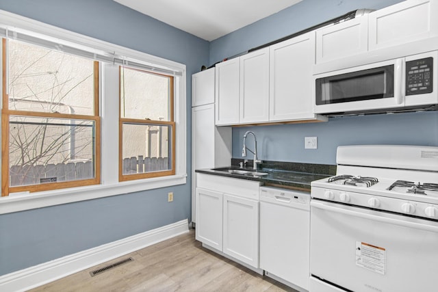 kitchen featuring sink, white appliances, white cabinets, and light wood-type flooring