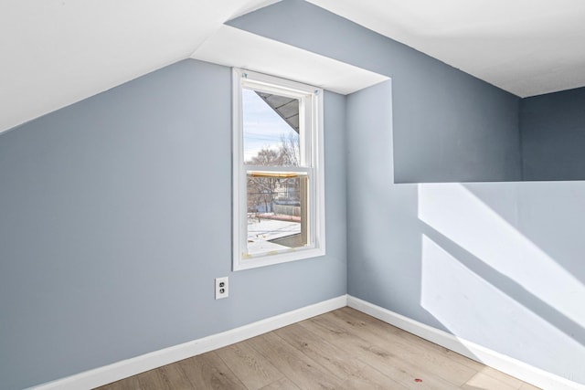 bonus room featuring lofted ceiling and light hardwood / wood-style floors