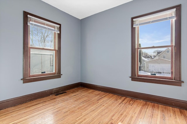 empty room with light hardwood / wood-style floors