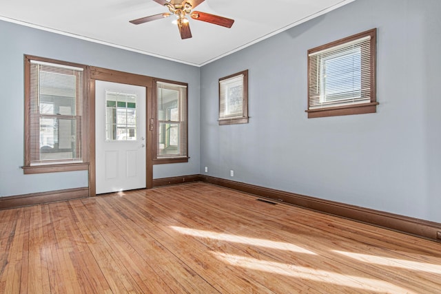 unfurnished room featuring ornamental molding, hardwood / wood-style floors, and ceiling fan