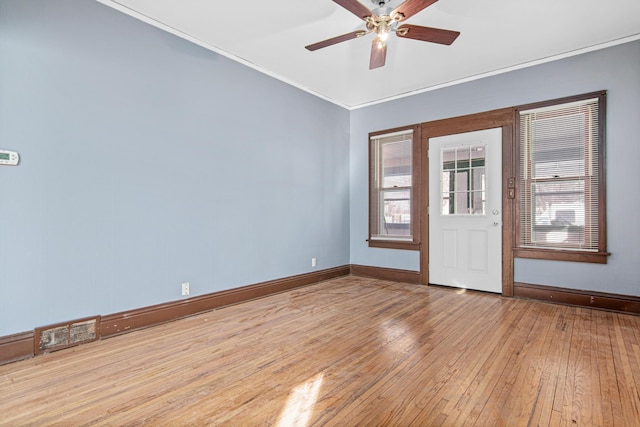 interior space featuring ceiling fan, ornamental molding, and light hardwood / wood-style floors