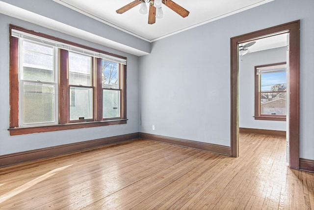 empty room with light hardwood / wood-style flooring, crown molding, plenty of natural light, and ceiling fan